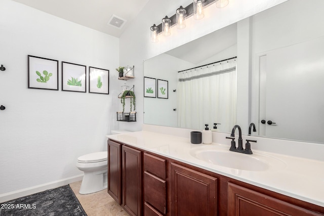 bathroom with vanity, lofted ceiling, and toilet