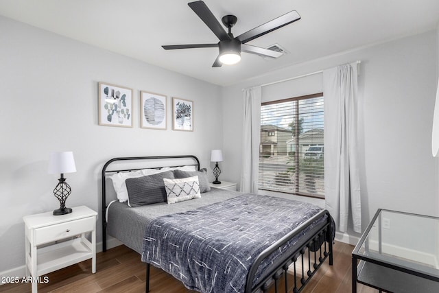 bedroom with dark wood-type flooring and ceiling fan