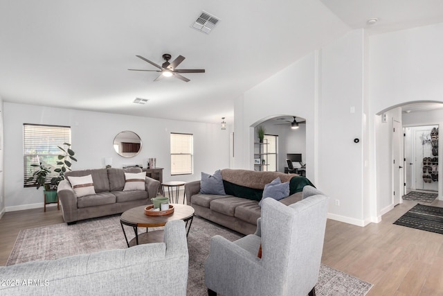 living room featuring ceiling fan, light hardwood / wood-style floors, and a healthy amount of sunlight