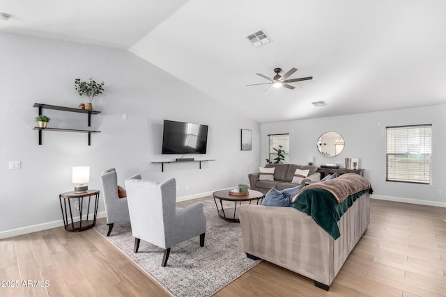 living room with lofted ceiling, light hardwood / wood-style flooring, and ceiling fan