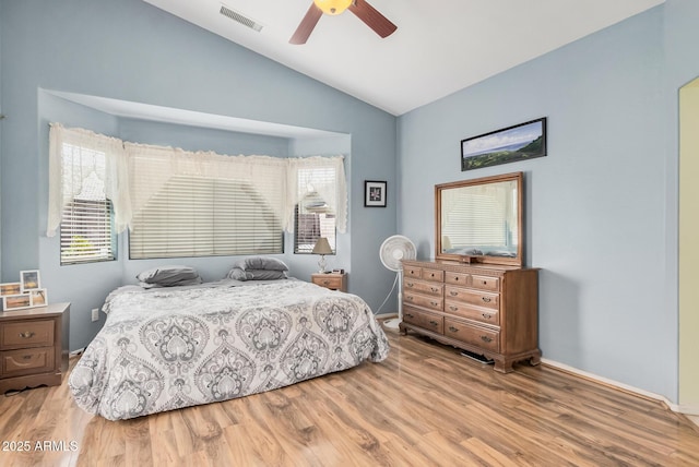 bedroom with lofted ceiling, wood finished floors, baseboards, and ceiling fan