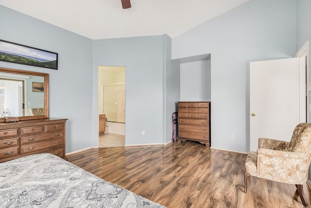bedroom featuring wood finished floors, baseboards, connected bathroom, and a ceiling fan