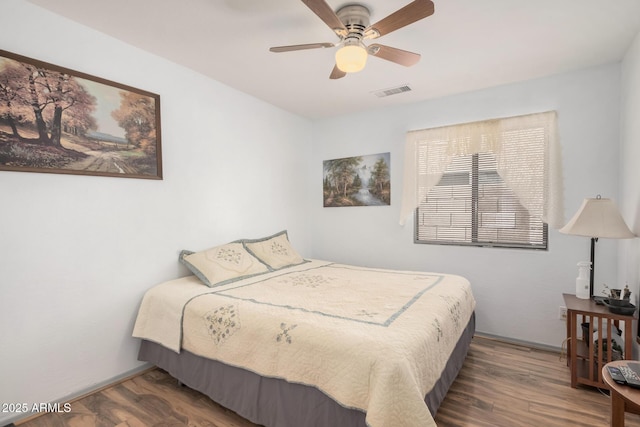 bedroom with wood finished floors and a ceiling fan