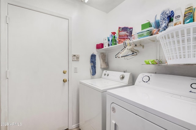 clothes washing area featuring independent washer and dryer