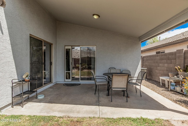 view of patio featuring fence and outdoor dining area