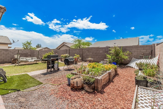 fenced backyard featuring a vegetable garden and a patio