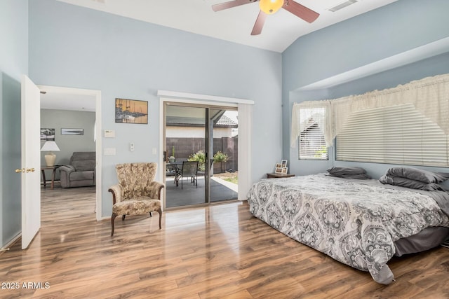 bedroom with access to outside, high vaulted ceiling, wood finished floors, and a ceiling fan