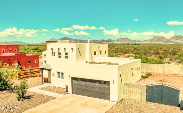 4207 N Santa Fe Ave, Douglas, AZ 85607 - view of front of property with a mountain view, concrete driveway, fence private yard, an attached garage, and stucco siding