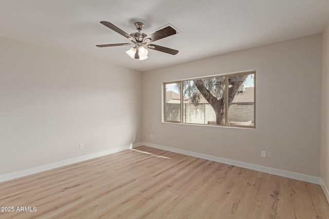 empty room featuring baseboards, a ceiling fan, and light wood-style floors