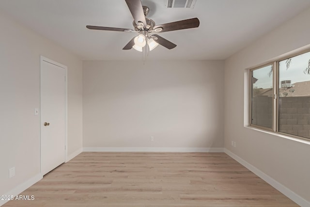 unfurnished room with light wood-type flooring, visible vents, and baseboards