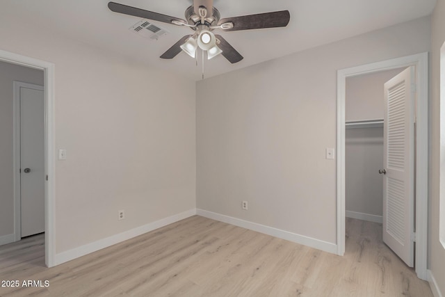 unfurnished bedroom with light wood-type flooring, baseboards, and a closet