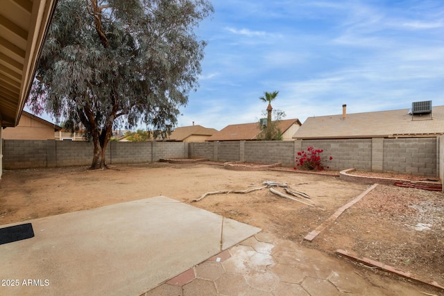 view of yard with central AC, a patio area, and a fenced backyard