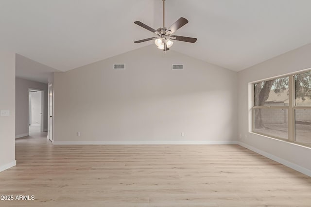 unfurnished room with light wood-style floors, lofted ceiling, visible vents, and baseboards