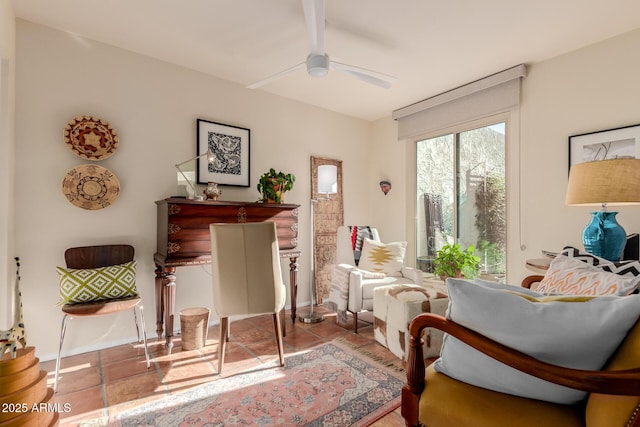 living area with ceiling fan and light tile patterned flooring