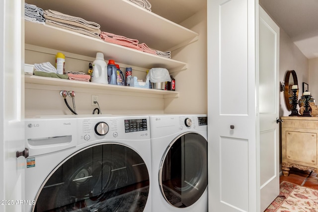 laundry room with washer and dryer and tile patterned flooring