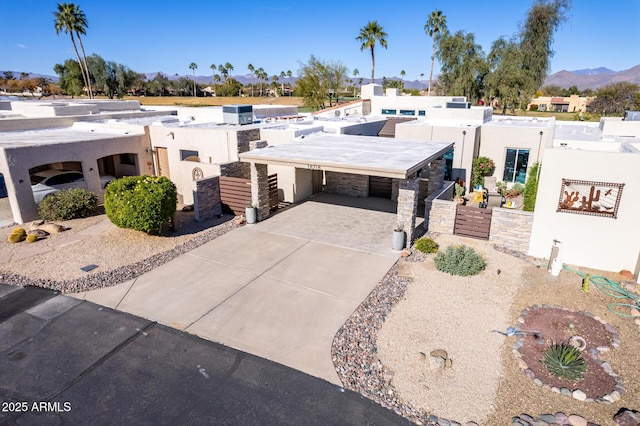 view of front of house featuring a mountain view and a carport