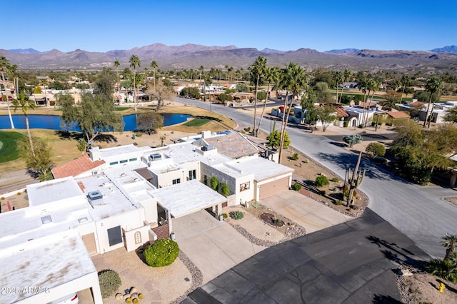 birds eye view of property with a water and mountain view