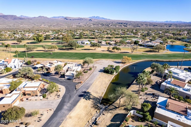 birds eye view of property with a water and mountain view