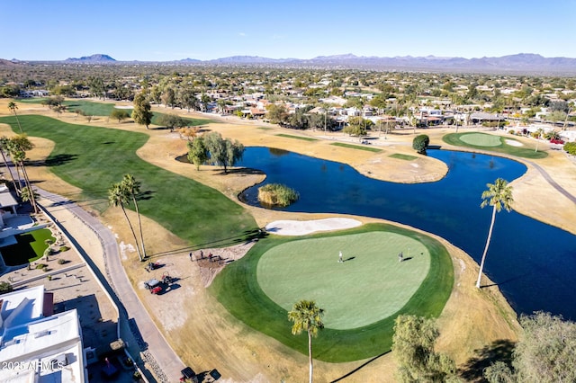 drone / aerial view featuring a water and mountain view