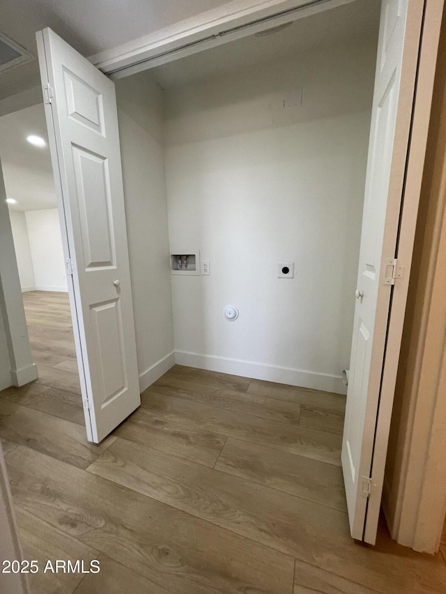 clothes washing area with hookup for a washing machine, laundry area, baseboards, light wood finished floors, and electric dryer hookup