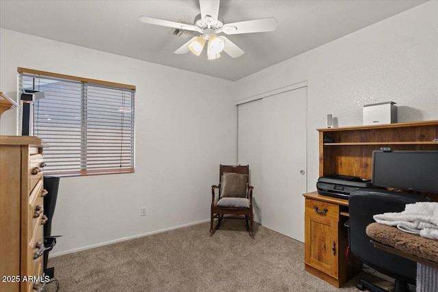 office area with light carpet, baseboards, and ceiling fan