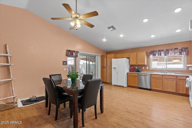 dining room featuring lofted ceiling, recessed lighting, light wood-type flooring, and visible vents