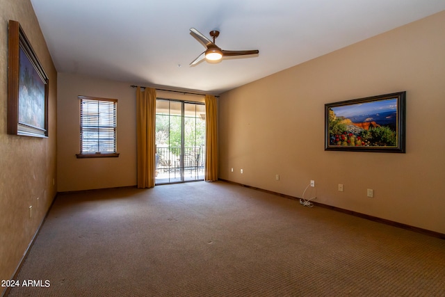 carpeted spare room with ceiling fan