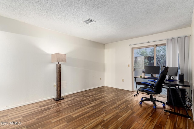 office with a textured ceiling and dark hardwood / wood-style flooring