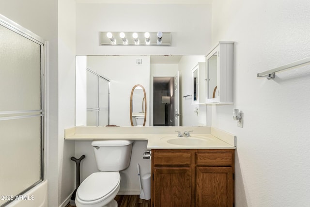 full bathroom featuring toilet, enclosed tub / shower combo, and vanity