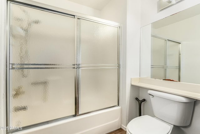 bathroom with toilet and enclosed tub / shower combo