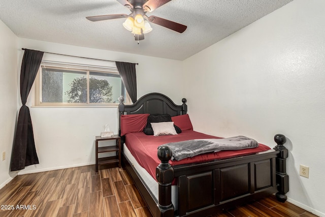 bedroom with a textured ceiling, ceiling fan, and dark hardwood / wood-style flooring