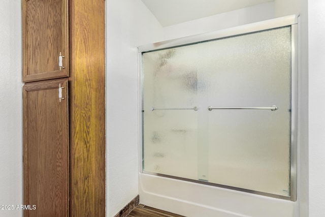 bathroom featuring shower / bath combination with glass door