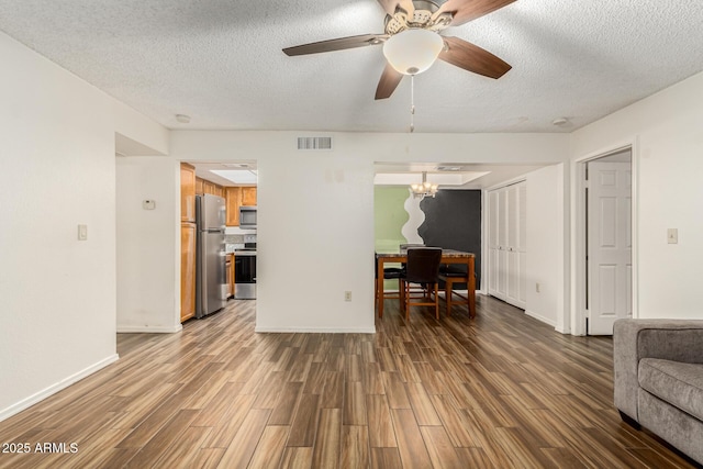 living room featuring ceiling fan, a textured ceiling, and hardwood / wood-style flooring