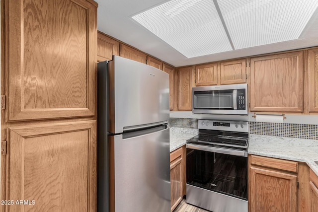 kitchen with light stone countertops and stainless steel appliances