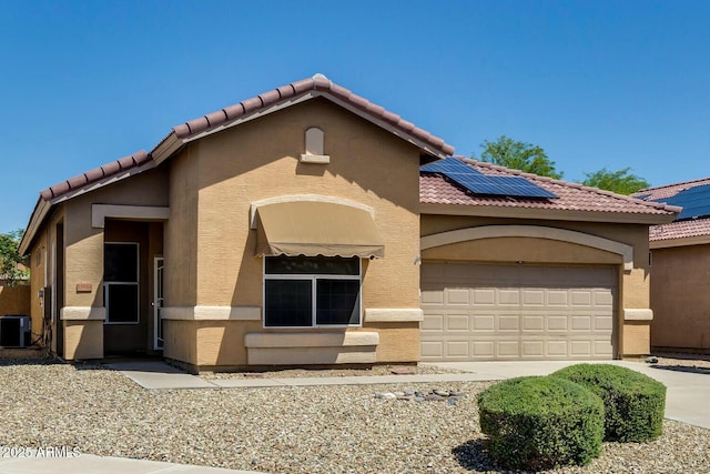 11664 W Eagle Ct, Surprise, AZ 85378 - mediterranean / spanish home featuring roof mounted solar panels, an attached garage, a tiled roof, and stucco siding
