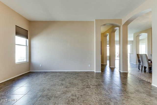 11664 W Eagle Ct, Surprise, AZ 85378 - empty room with arched walkways and baseboards