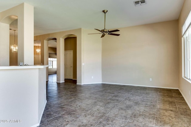 11664 W Eagle Ct, Surprise, AZ 85378 - unfurnished living room featuring baseboards, visible vents, arched walkways, and ceiling fan