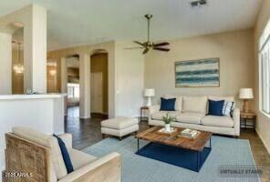11664 W Eagle Ct, Surprise, AZ 85378 - living area featuring wood finished floors, a healthy amount of sunlight, and a ceiling fan