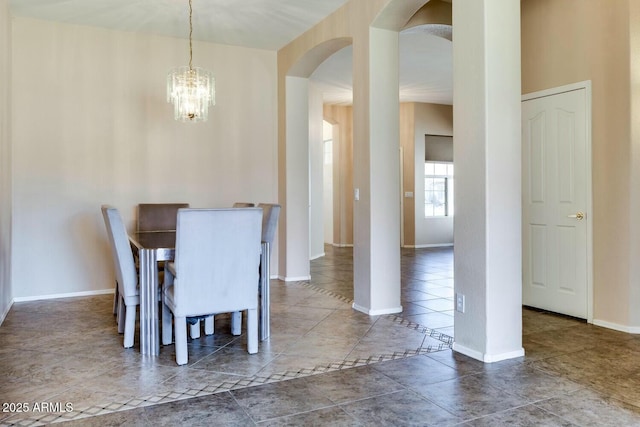 11664 W Eagle Ct, Surprise, AZ 85378 - dining room with arched walkways, tile patterned flooring, a chandelier, and baseboards