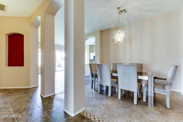 11664 W Eagle Ct, Surprise, AZ 85378 - dining space featuring tile patterned floors, visible vents, arched walkways, and a notable chandelier