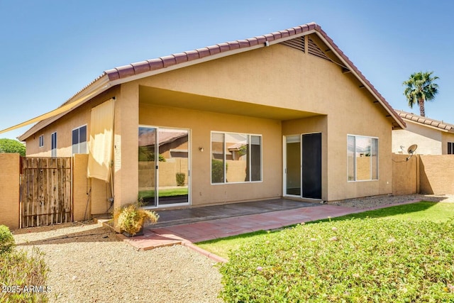 11664 W Eagle Ct, Surprise, AZ 85378 - back of property featuring stucco siding, fence, a patio area, and a tiled roof