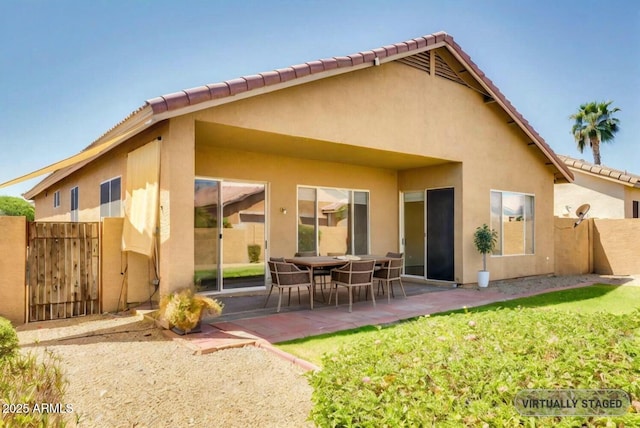 11664 W Eagle Ct, Surprise, AZ 85378 - back of house with a gate, a tiled roof, fence, a patio, and stucco siding