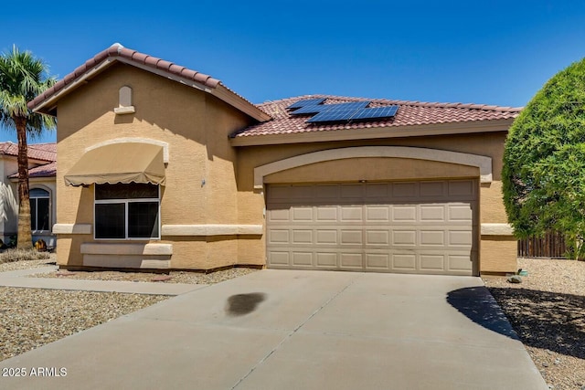 11664 W Eagle Ct, Surprise, AZ 85378 - mediterranean / spanish-style home featuring solar panels, a tiled roof, a garage, and stucco siding
