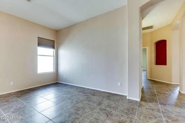 11664 W Eagle Ct, Surprise, AZ 85378 - tiled spare room with arched walkways, visible vents, and baseboards