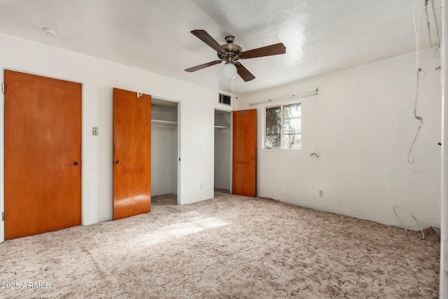 2002 W Whitton Ave, Phoenix, AZ 85015 - unfurnished bedroom featuring carpet flooring, two closets, and a ceiling fan