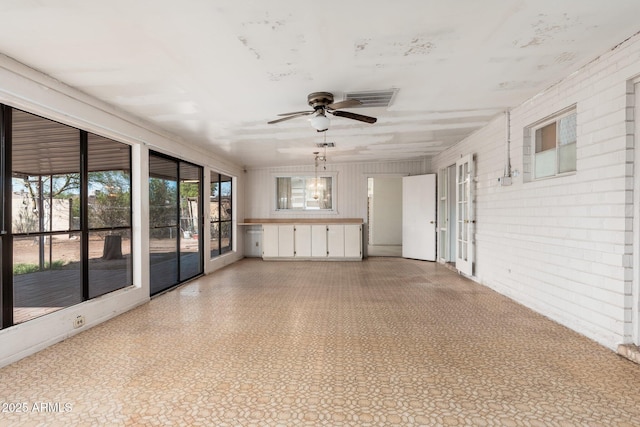 2002 W Whitton Ave, Phoenix, AZ 85015 - unfurnished sunroom featuring brick wall and ceiling fan