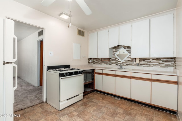 2002 W Whitton Ave, Phoenix, AZ 85015 - kitchen featuring white appliances, stone finish floors, light countertops, and decorative backsplash
