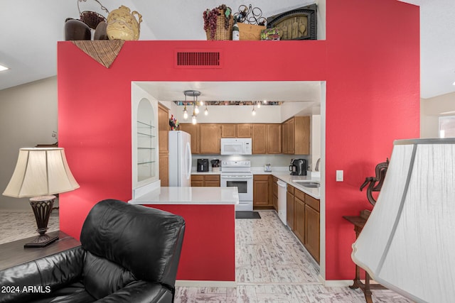 kitchen with lofted ceiling, sink, and white appliances