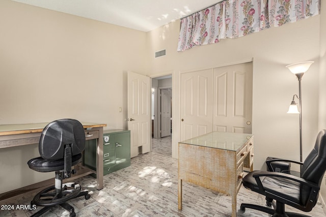 home office featuring a towering ceiling