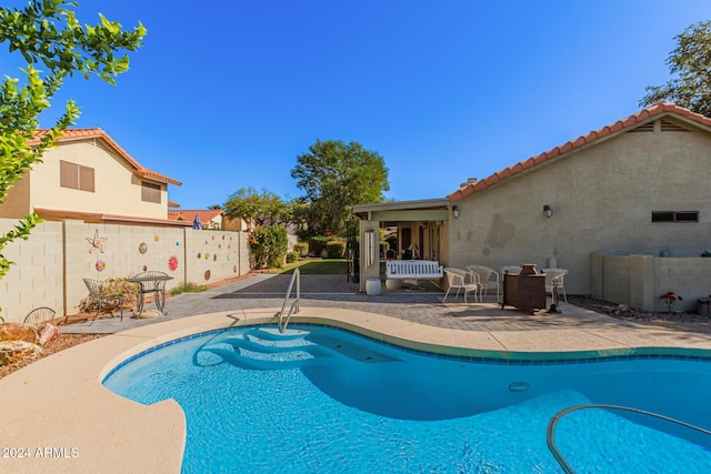 view of swimming pool featuring a patio area